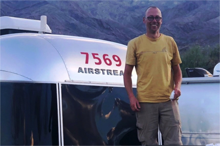 Man standing in front of airstream trailer